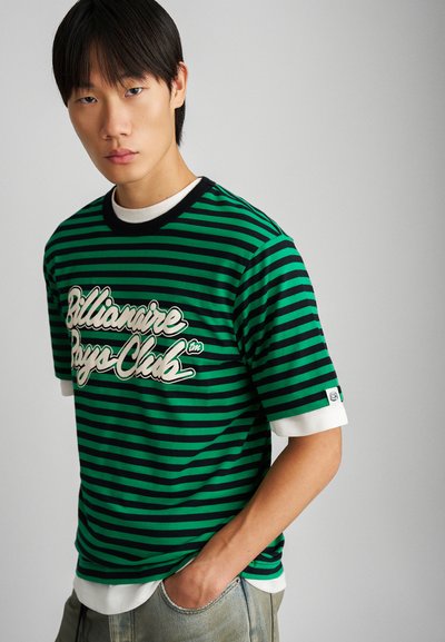 Green and black striped t-shirt with a white graphic logo, short sleeves, and a contrasting black neckline. Features white accent cuffs.