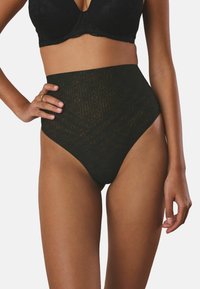High-waisted black lingerie made of lace with a floral pattern. Smooth texture, full coverage, accentuated waistline.