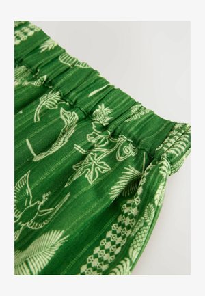 Zöld szövet, elasztikus derékpánttal, fehér botanikai és geometriai mintákkal. Enyhén fényes, texturált és puha esésű.