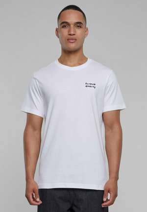 White cotton t-shirt with short sleeves and a crew neck. Features a small black text graphic on the left chest: "Au revoir".
