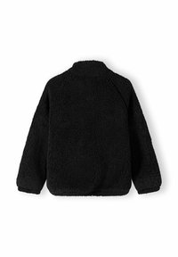 Veste en polaire noire avec une surface texturée et douce. Présente une coupe décontractée, des manches longues et un petit col. Aucun hardware ou motif visible.