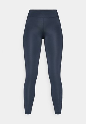 Navy leggings made of stretchy material, featuring a high waistband and smooth texture. Side print accents the lower leg.