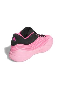 Pink and black athletic shoe with a wave-like textured design, featuring a cushioned sole and contrasting laces. Branding visible on the heel.