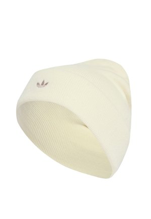Cream-colored knit beanie with a ribbed texture, featuring a small brown logo accent on the front. Soft, flexible fabric for comfort.