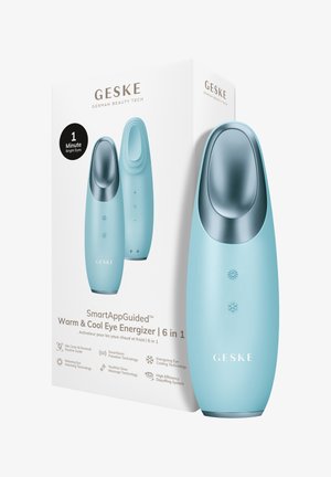 Lyseblåt GESKE Warm & Cool Eye Energizer-enhed med metalapplikator, der viser varme- og koldemodusikoner ved siden af produktets emballage.