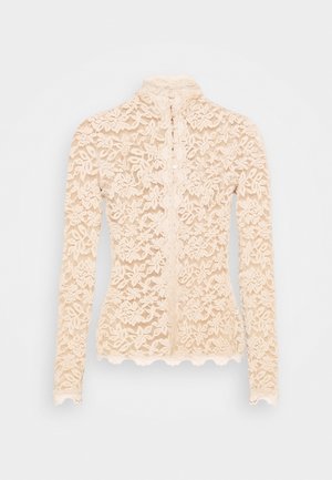 Blusa beige in pizzo a maniche lunghe con motivo floreale, bordi smerlati, collo alto e chiusura frontale con bottoni.