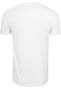 T-shirt bianca in cotone con taglio classico, maniche corte, collo rotondo e texture liscia; senza motivi o accenti visibili.