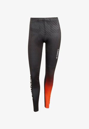 Leggings neri in tessuto elasticizzato, con un gradiente dal nero all'arancione nella parte inferiore, decorati con motivi texture e un logo sul lato.