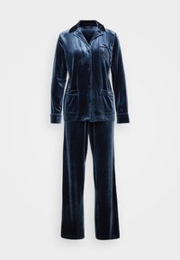 Conjunto de pijama de veludo azul marinho, apresentando uma blusa de botão de manga longa com colarinho e bolso, acompanhada de calças combinando com pernas largas.