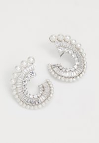 Silver-tone earrings featuring a crescent shape with alternating rows of pearls and clear rhinestones, combining smooth and faceted textures.