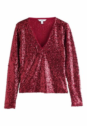 Haut à manches longues en sequins rouge profond avec col en V, tissu texturé et ourlet légèrement court.