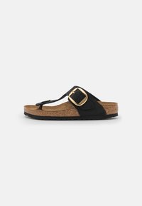 Infradito nera con soletta in sughero, dotata di un accento in fibbia dorata, suola in gomma e cinturini in suede. Design piatto ideale per un abbigliamento casual.