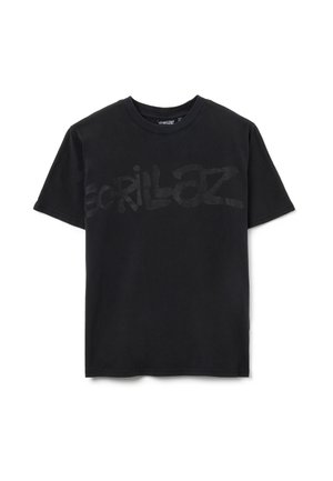 Zwarte katoenen t-shirt met een groot, semi-transparant "Gorillaz" logo aan de voorkant. Standaard ronde hals en korte mouwen, gladde textuur.