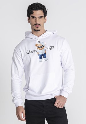 Hvid hoodie lavet af bomuld, med et bjørne grafik iført solbriller og denimbukser, med en frontlomme og ribbede manchetter.