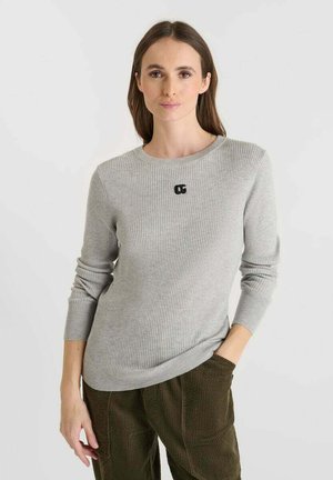 Grey knitted sweater with ribbed texture, round neckline, and black logo detail on the front. Features long sleeves and a slim fit.
