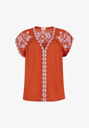 Kurzärmlige Bluse in Rostorange mit weißer Blumenstickerei an Ärmeln, Ausschnitt und vorderer Mitte.