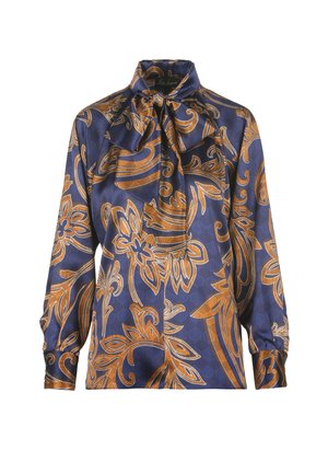 Blouse bleu marine avec un motif floral doré. Fabriquée en tissu soyeux, elle possède un col haut avec un nœud à nouer et des manches longues.