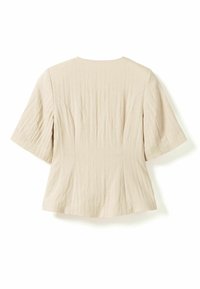 Blouse beige pour femme à manches courtes, en tissu texturé, coupe ajustée avec des détails subtils de coutures verticales, vue de dos.