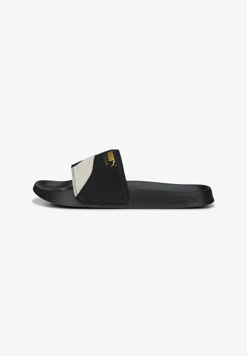 Black and gray slide sandal with a smooth rubber sole, suede upper, and gold logo detailing. Features a wide strap that covers the instep.