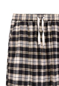 Sort-hvide ternede pyjamasbukser med elastik i taljen og hvid snøre. Blødt stof med ternet mønster og lyse beige accenter.