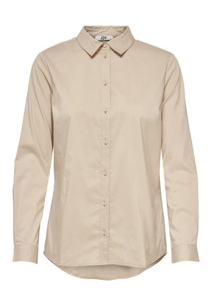 Chemise beige à manches longues avec boutons, col pointu et ourlet arrondi, en tissu lisse.