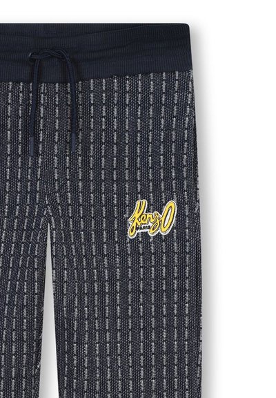 Joggers marins à motif, avec des rayures texturées, une taille élastique, un cordon de serrage et un logo "Kenzo" brodé en jaune. Tissu doux.