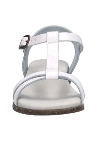 White leather sandal with thin straps, a buckle closure, and a soft grey interior lining. Low-profile sole with a textured brown outsole.