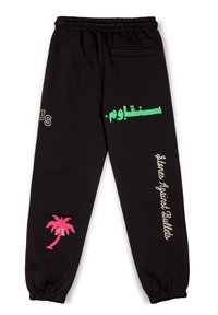 Schwarze Jogginghose mit elastischem Bund. Mit grüner und weißer Schrift, einem rosa Palmenmotiv und einer Gesäßtasche.