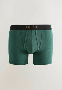 Boxer da uomo verde scuro con elastico nero che presenta il nome del marchio "NEXT" in lettere dorate.