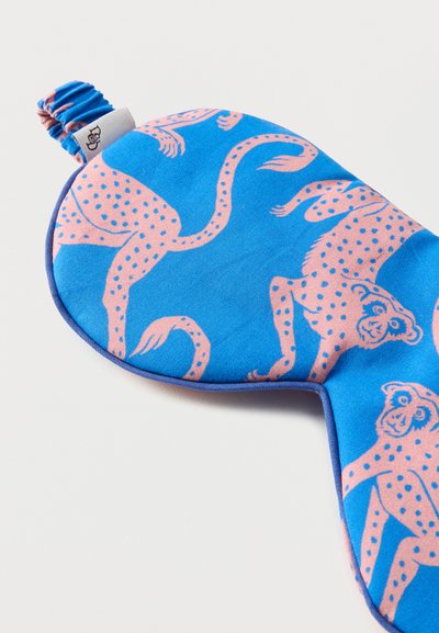 Μπλε υφασμάτινη μάσκα ύπνου με ροζ λεοπάρ μοτίβο με κηλίδες και ελαστικό λουρί με μικρή υφασμάτινη ετικέτα.