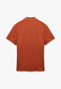 Kortärmad polo i rostorange med vit kontrastkrage. Slät textur och ren, minimalistisk design.