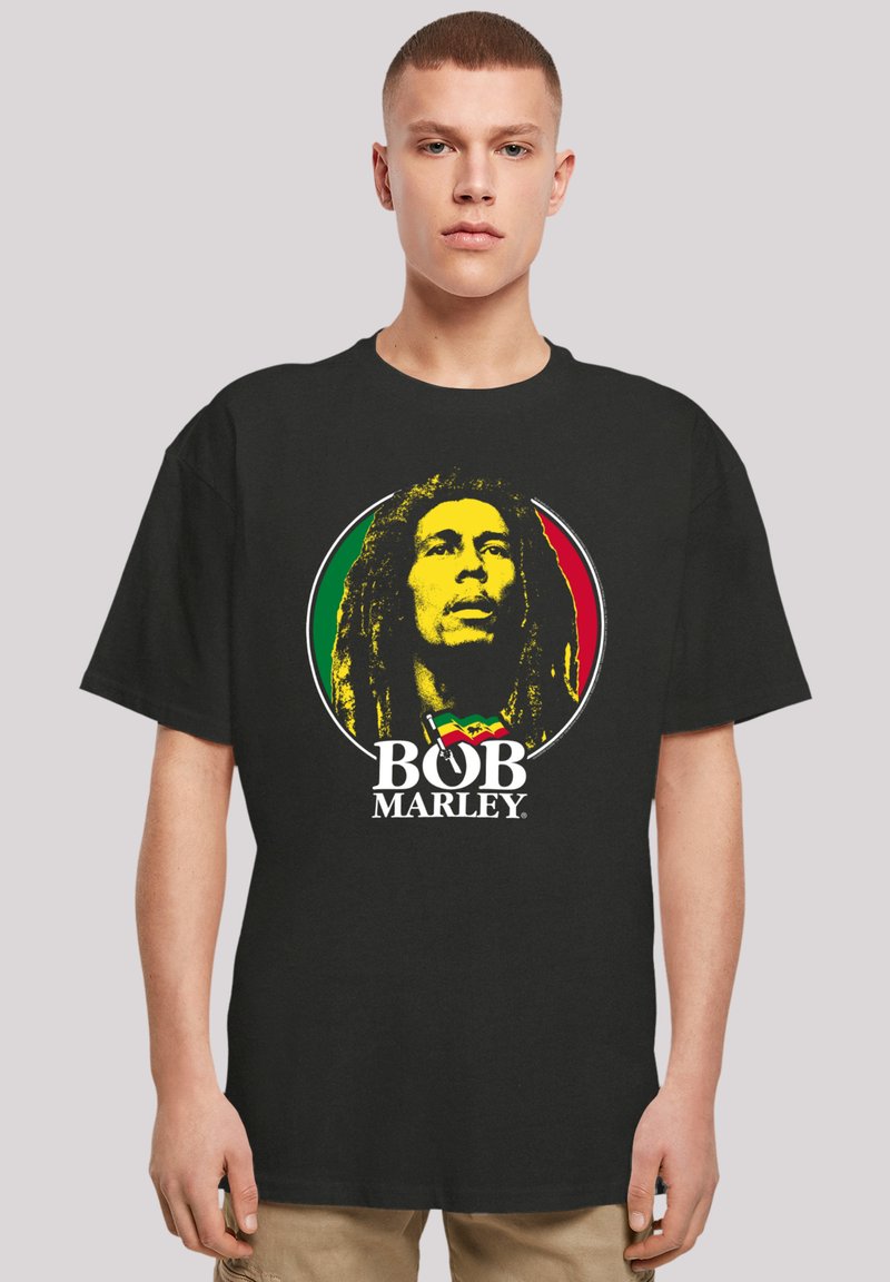 Black cotton t-shirt featuring a circular graphic of Bob Marley in yellow, surrounded by red and green, with "BOB MARLEY" printed below.