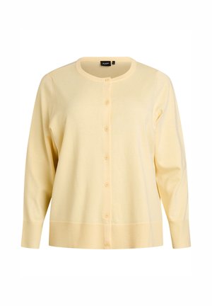 Geel vest met een ronde hals, lange mouwen en knopen aan de voorkant. Gemaakt van een zachte stof met geribbelde manchetten en zoom.