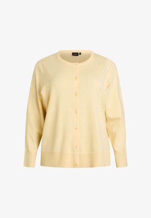 Żółty kardigan z okrągłym dekoltem, długimi rękawami i zapinany na guziki z przodu. Wykonany z miękkiej tkaniny z prążkowanymi mankietami i dołem.