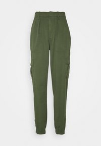 Green cargo pants made from a smooth fabric. Features include elastic cuffs, multiple pockets, and a high waist design.