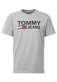 Šedé bavlněné tričko s výraznou grafikou "TOMMY JEANS" v černé barvě, doplněnou červeným a modrým akcentem ve věnování loga. Klasický design s kulatým výstřihem.