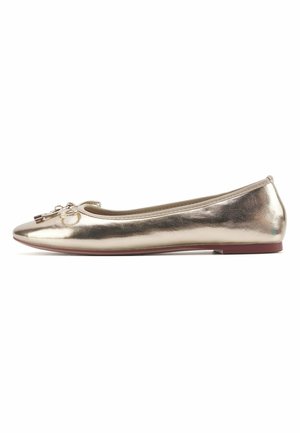 Gold metallic ballet flat with a rounded toe, featuring a decorative bow on the front and a slight heel with a smooth texture.