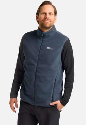 Fleece vest in dark blue, featuring a high collar, full zip, and side pockets. Includes a logo on the chest and layered long sleeves.