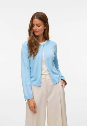 Light blue cardigan made from soft fabric with a round neckline, long sleeves, and a single button closure. Paired with cream-colored trousers.