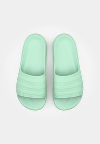 Mint green slide sandals made of textured rubber, featuring wide straps with a woven pattern and an open toe design.
