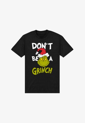 Camiseta negra de algodón que muestra un Grinch verde de estilo caricaturesco con un sombrero rojo de Santa, con texto en negrita blanco y verde: "NO SEAS UN GRINCH."