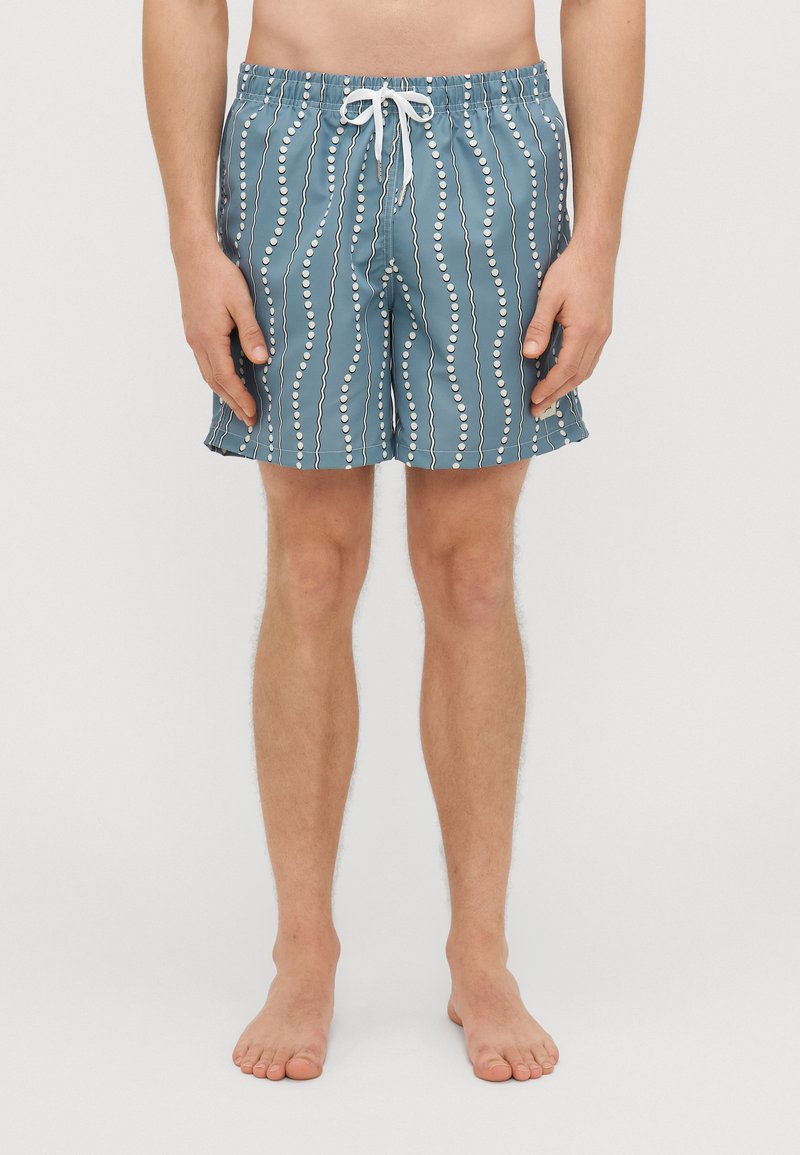Blue swim shorts with a white circular pattern, elastic waistband, drawstring closure, and a relaxed fit. Smooth texture and knee-length.