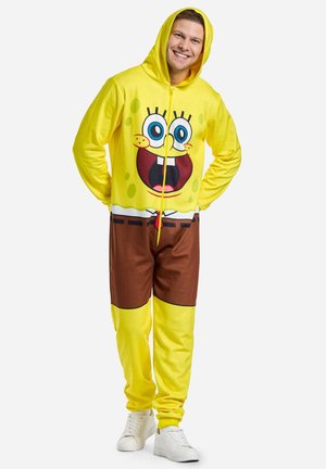 Geltona su kapuci vienodera su dideliu SpongeBob SquarePants piešiniu, rudos spalvos kelnių dalimi ir užtrauktuko uždarymu. Slydus, minkštas audinys.