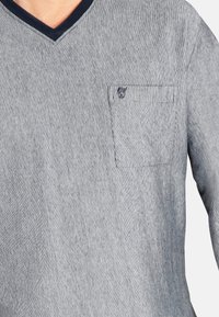 Grau gestreiftes Langarmshirt mit V-Ausschnitt, marineblauem Akzent am Kragen und einer Tasche auf der linken Brust mit einem Logo.