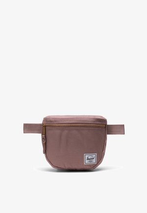 Herschel bæltetaske i dæmpet rosa med en gylden lynlås, stofkonstruktion, flad rektangulær form og et signaturlogo-patch på forsiden.