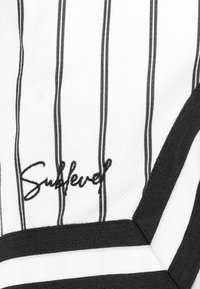 Black and white striped fabric with a textured finish, featuring an embroidered "Sublevel" logo and a solid black trim.