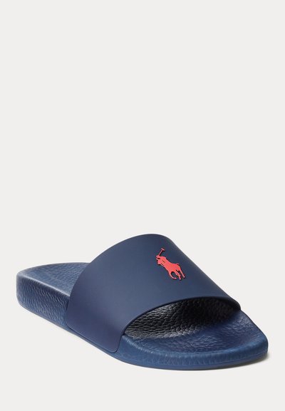 Navy blue slide sandal with textured footbed and red Polo Ralph Lauren logo on the strap, angled left on a white background.