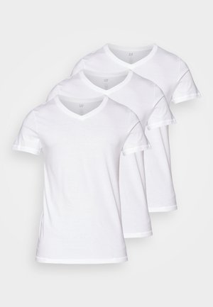 Trije bijeli majice s V izrezom, izrađene od mekog pamuka, s kratkim rukavima i kontrastnim rebrastim obrubom duž izreza i rukava.
