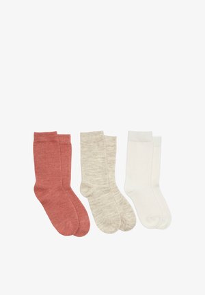 Trois paires de chaussettes montantes unies en rose poudré, beige clair et blanc, disposées côte à côte sur un fond blanc.