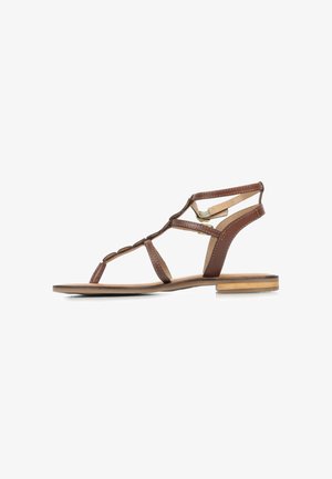 Brown flat sandals with thin straps, featuring a geometric design. Material appears to be synthetic with a wooden accent on the sole.